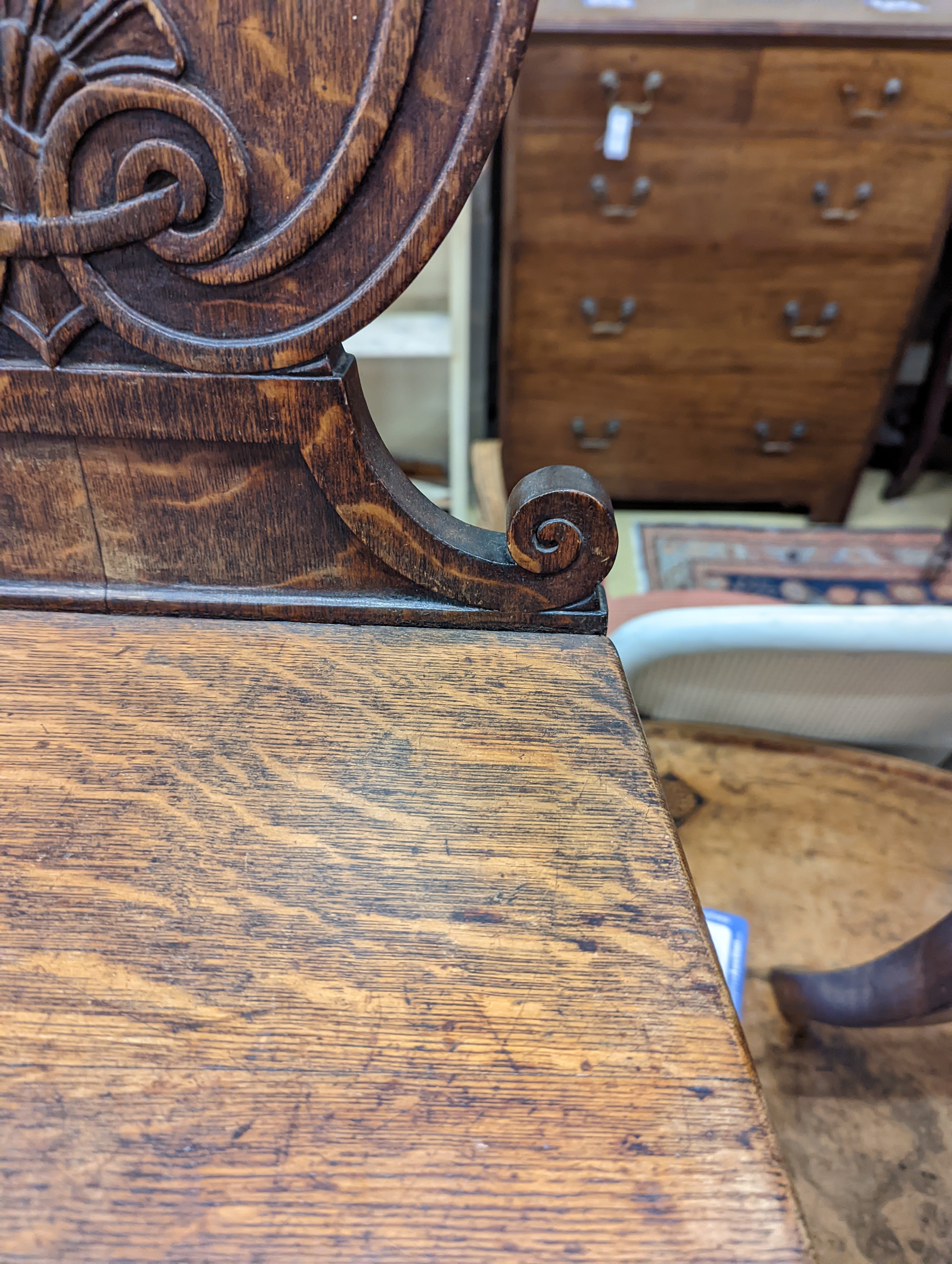 A pair of Victorian oak hall chairs with painted armorials, width 43cm, depth 39cm, height 94cm